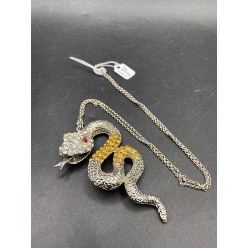 764 - A large diamonte snake pendant on silver chain