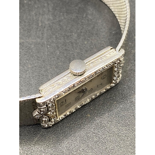 800 - A ATTRACTIVE PLATINUM AND DIAMOND LADIES WRIST WATCH INTEGRAL STRAP 65MM DIAMETER 35.5 GMS