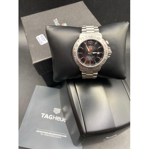 835 - A TAG HEUER formula one gents wrist watch with date aperture and alarm in box with papers