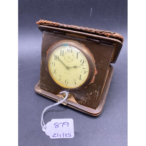 879 - A leather cased eight day travel clock