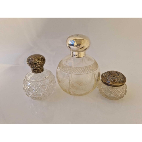 935 - Two silver mounted cut glass scent bottles and a mounted jar