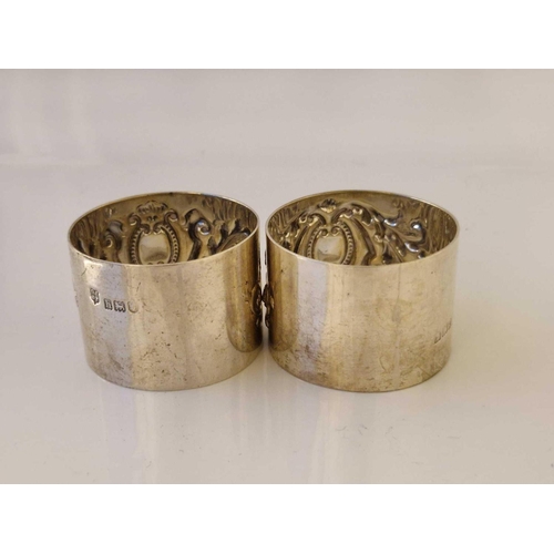 938 - Pair of napkin rings each embossed with a cartouche. London 1903. 63gms