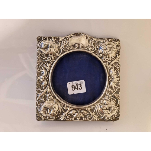 943 - Photo frame with circular aperture and embossed cherub border. 6 in high. Birmingham 1904