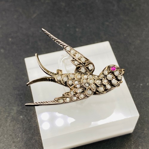 337 - A ANTIQUE VICTORIAN DIAMOND SET SWALLOW BROOCH WITH A RUBY EYE