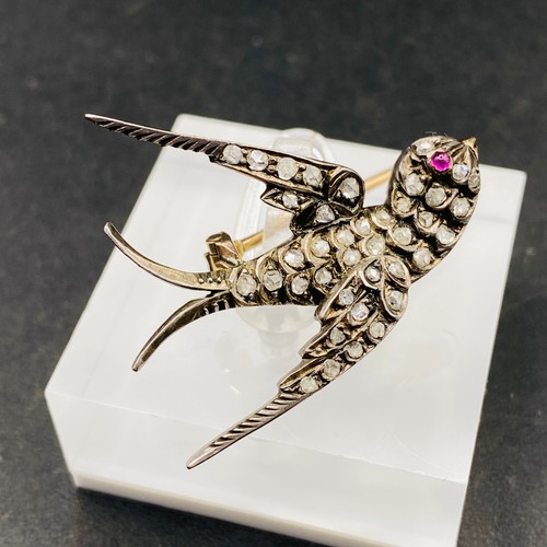 337 - A ANTIQUE VICTORIAN DIAMOND SET SWALLOW BROOCH WITH A RUBY EYE