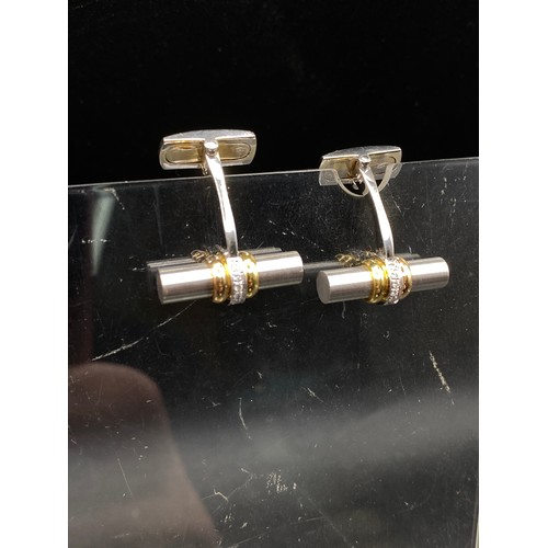 743 - A PAIR OF DIAMOND TWO COLOUR DRESS CUFFLINKS 18CT GOLD THE SOLID TUBE DESIGN ENCIRCLED BY DIAMONDS B... 