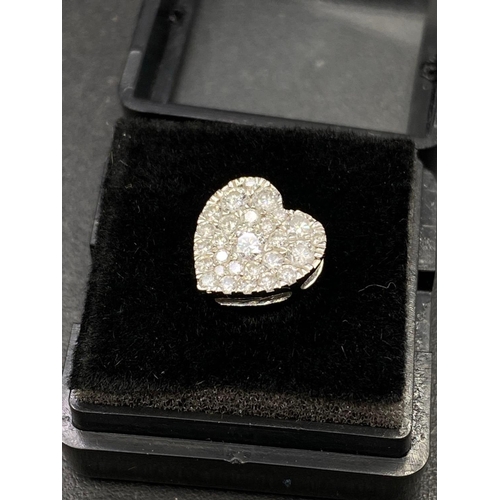 115 - A pretty diamond heart set with 0.30 of a carat full cut diamonds in high carat gold