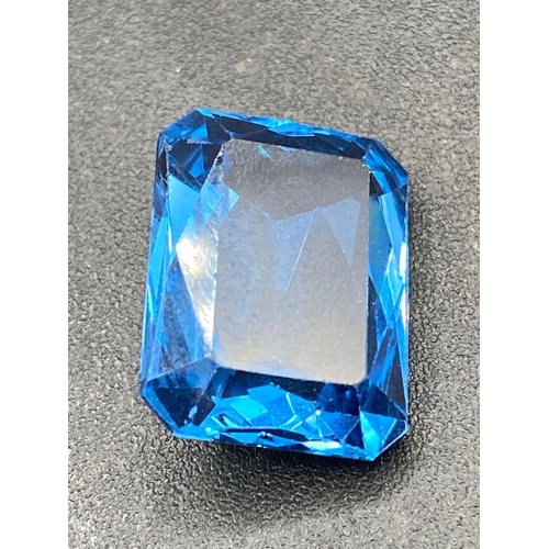 116 - A good deep blue Brazilian topaz special trapeze cut 22 carats