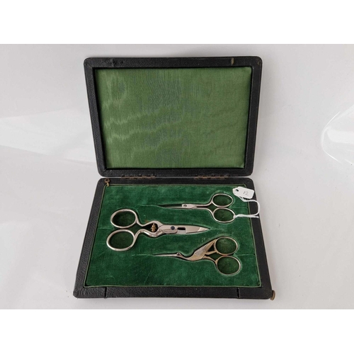 12 - A attractive cased set of three scissors