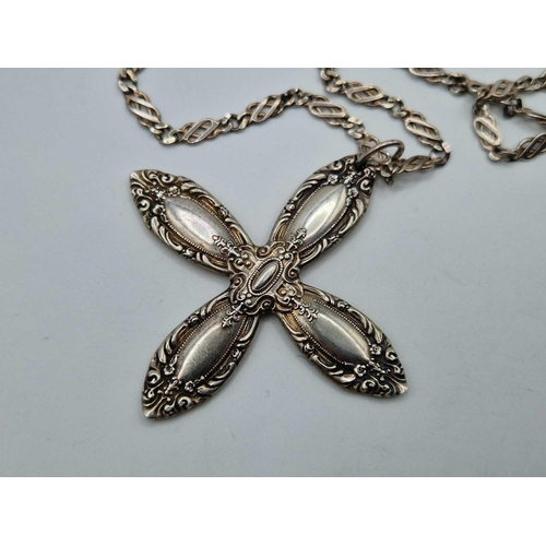 127 - A fancy silver cross on silver neck chain 18 inch 36 gms