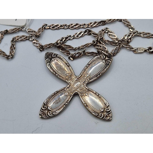 127 - A fancy silver cross on silver neck chain 18 inch 36 gms