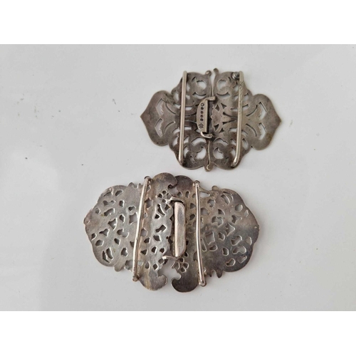 154 - A silver nurses buckle and a plated example