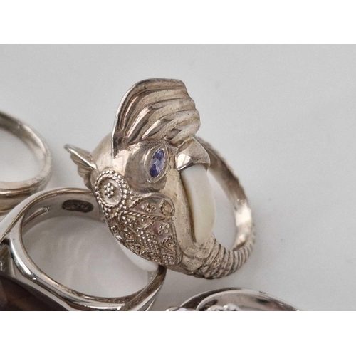 226 - Four silver rings, one with elephant design, 37 g