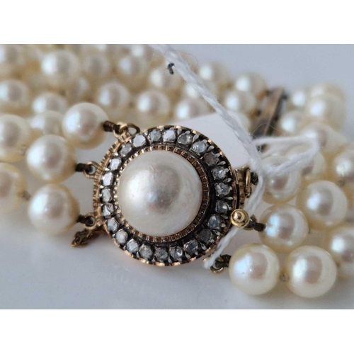 233 - A VICTORIAN TRIPLE STRAND PEARL BRACELET WITH 48 DIAMONDS OVER DIVIDERS AND CLASP