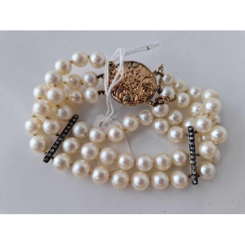 233 - A VICTORIAN TRIPLE STRAND PEARL BRACELET WITH 48 DIAMONDS OVER DIVIDERS AND CLASP