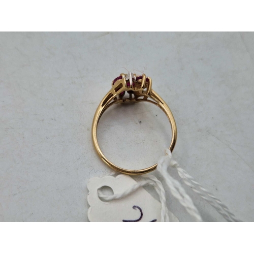 262 - A nine stone ruby and diamond ring, size R, 2.5 g.