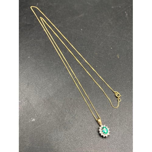 294 - A diamond and green gem stone pendant on gold chain 22 inch