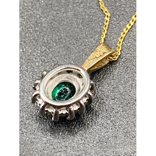 294 - A diamond and green gem stone pendant on gold chain 22 inch