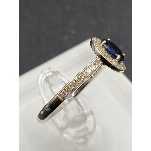 295 - A attractive sapphire and diamond cluster ring with full diamond shoulders in 9ct white gold size N ... 