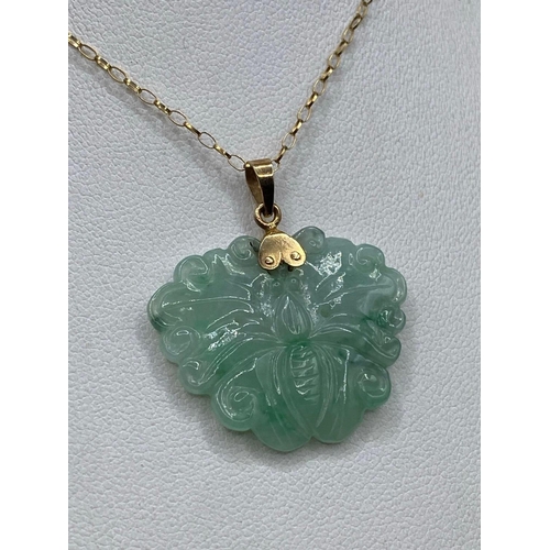 297 - A jade and gold carved butterfly pendant 14ct gold with gold chain 18 inch