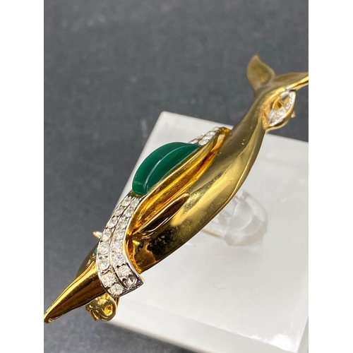 311 - A flying dolphin brooch with gem set body and eye with makers mark