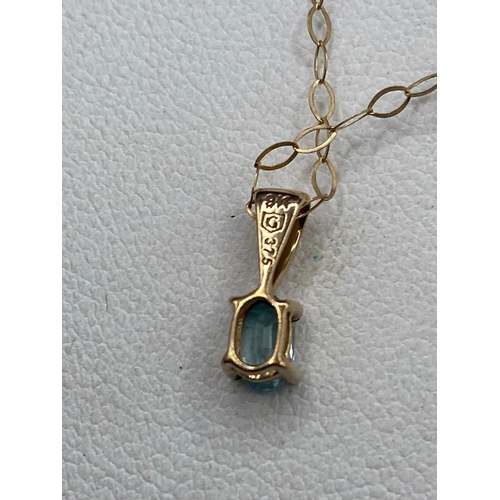 313 - A pretty aquamarine drop pendant on gold chain 18 inch