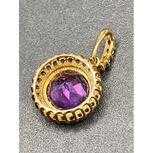 319 - A amethyst and tanzernite pendant with tanzernite loop