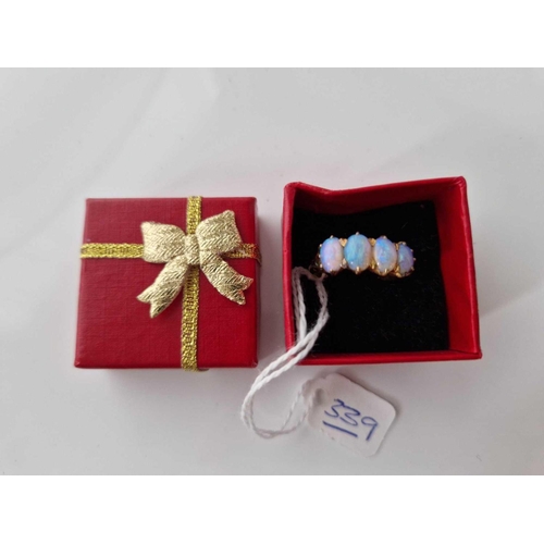 339 - A four stone opal ring set in high carat gold size N 5.4 gms