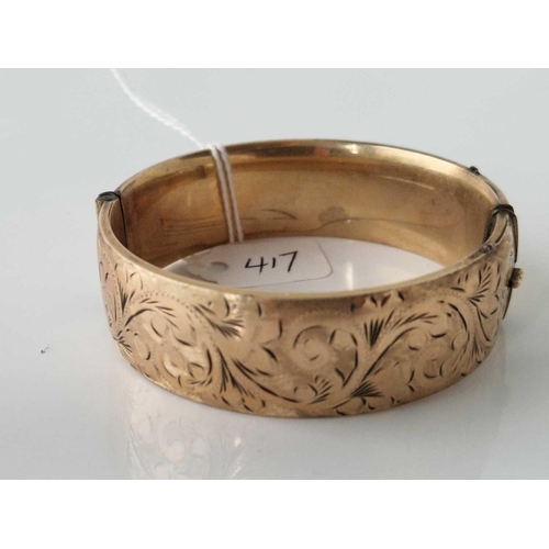 417 - A wide rolled gold bangle