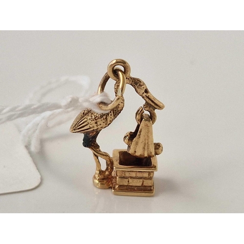 441 - A unusual stork baby articulated charm, 9ct, 2.9 g.