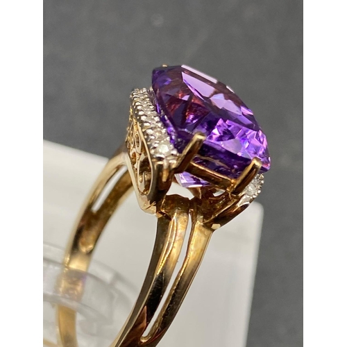 512 - A large amethyst and diamond dress ring the multi faceted fancy cut amethyst surrounded by diamonds ... 