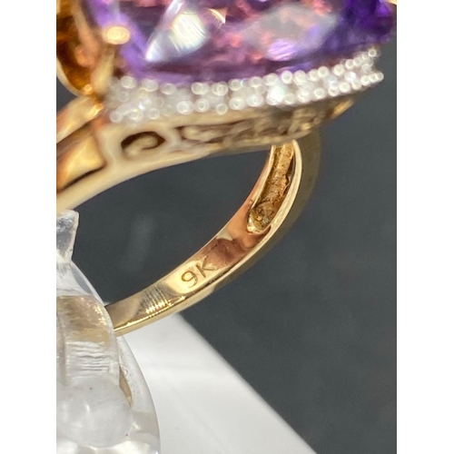 512 - A large amethyst and diamond dress ring the multi faceted fancy cut amethyst surrounded by diamonds ... 