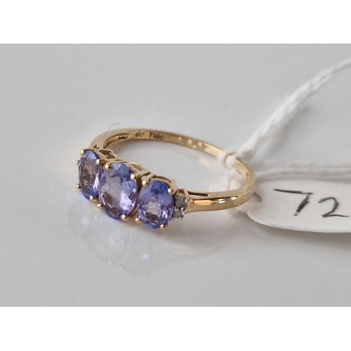 72 - A three stone tanzanite ring with diamond shoulders 10ct gold size S 1.9 gms