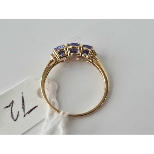 72 - A three stone tanzanite ring with diamond shoulders 10ct gold size S 1.9 gms