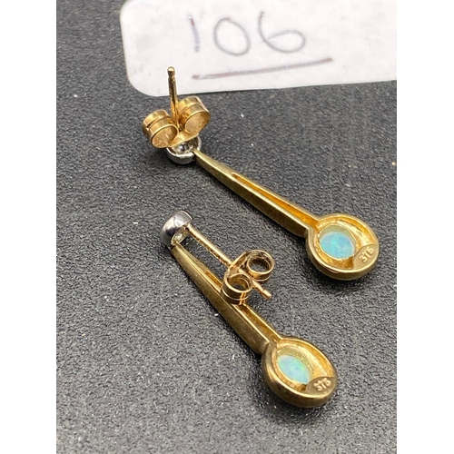 106 - A pair of diamond and opal earrings 9ct 22 mm drop 2 gms