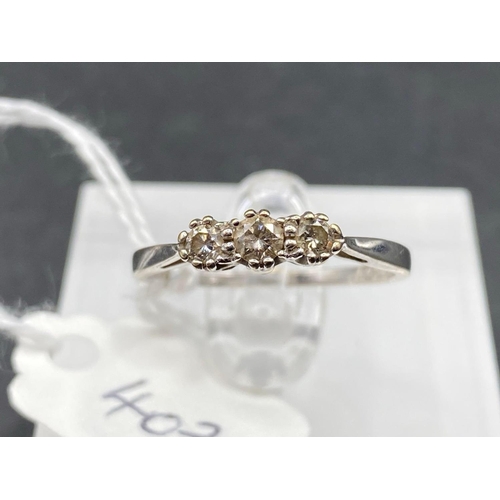 403 - A white gold three stone diamond ring 18ct gold 0.25 carats size P 2.1 gms