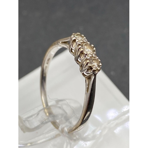 403 - A white gold three stone diamond ring 18ct gold 0.25 carats size P 2.1 gms