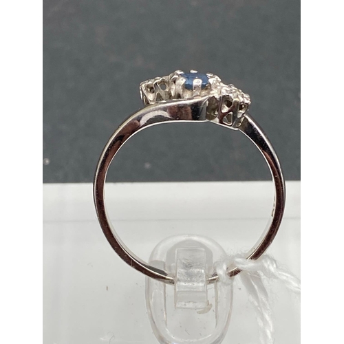 408 - A white gold diamond and sapphire three stone ring 9ct size P