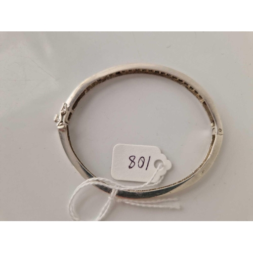 108 - A silver stone set hinged set bangle