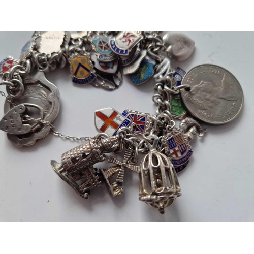 12 - A silver charm bracelet 104 gms