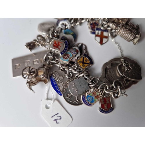 12 - A silver charm bracelet 104 gms