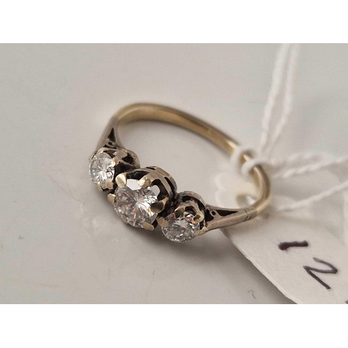 121 - A TWO COLOUR DIAMOND THREE STONE RING 18CT GOLD SIZE J TOTAL CARAT 0.65