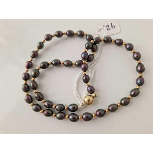 126 - A string of iridescent pearls separated by 9ct beads with 9ct clasp