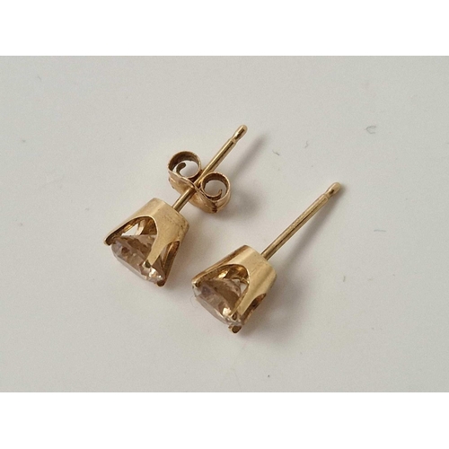 145 - A PAIR OF GOLD MOUNTED DIAMOND EARRINGS