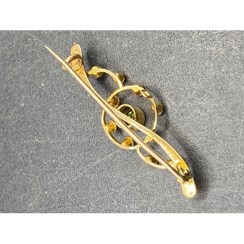 243 - A antique peridot and pearl brooch 15ct gold