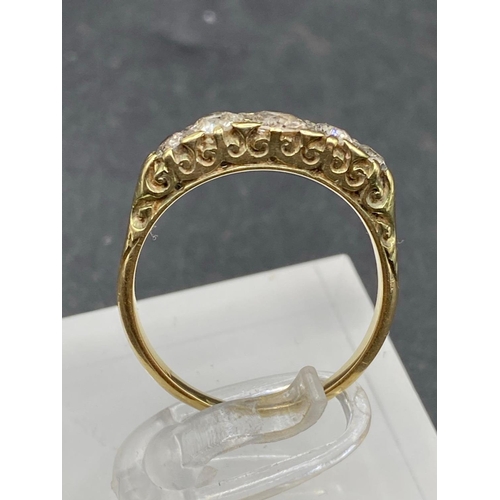 244 - A VICTORIAN FIVE STONE DIAMOND GRADUATED RING IN HAND CARVED MOUNT 18CT GOLD SIZE P 3.2 GMS