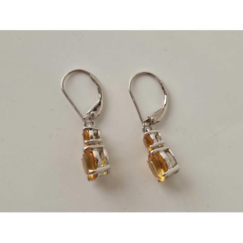 287 - A pair of white gold two stone drop citrine earrings 2.5 gms