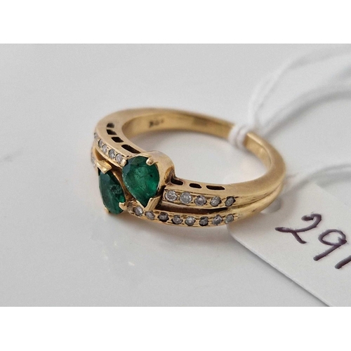 291 - A EMERALD AND DIAMOND CROSS OVER RING 18CT GOLD SIZE M 4.6 GMS