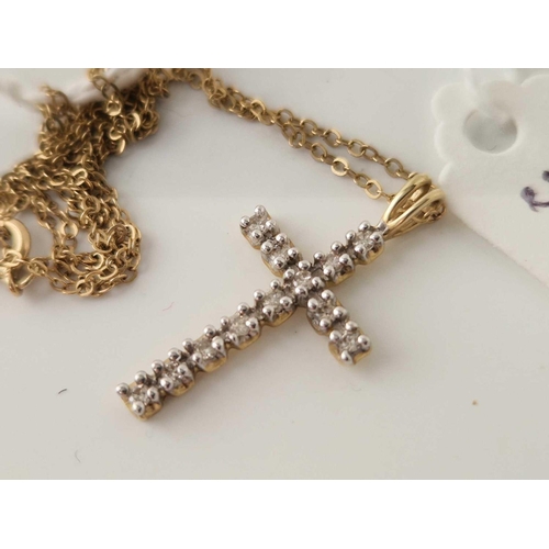 304 - A 10ct gold diamond cross on a 9ct chain 18 inch