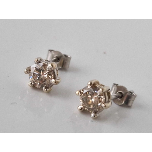 326 - A PAIR OF DIAMOND STUD EARRINGS IN 18CT GOLD AND PLATINUM DIAMOND CONTENT 1.10 CARAT